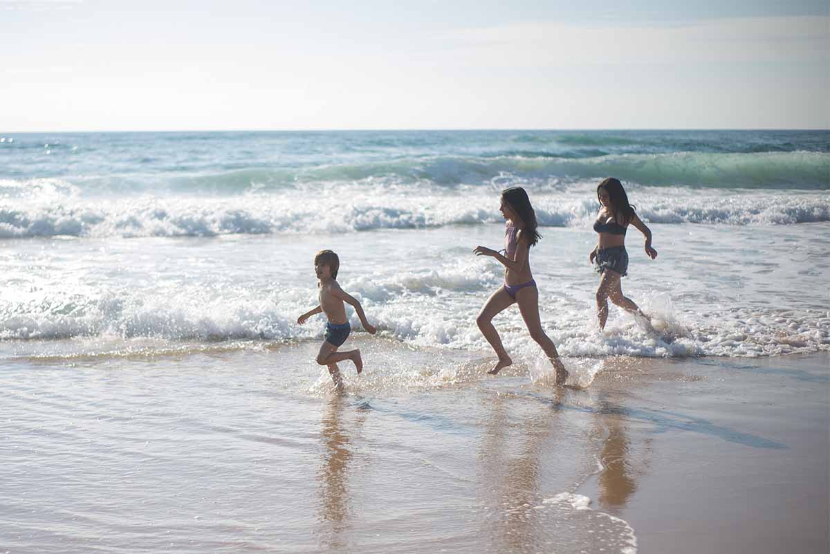 kids running on the beach - life insurance in spain