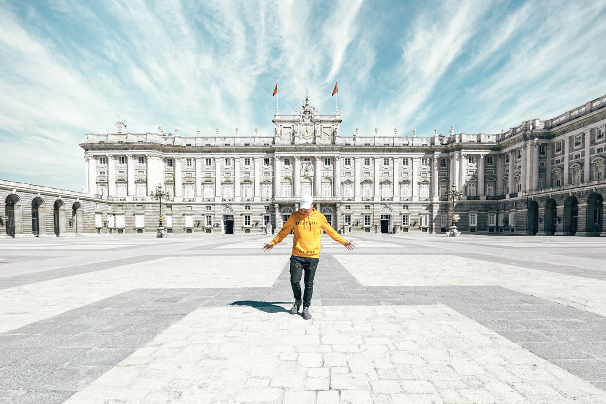 A man in a yellow shirt in a square living in Madrid