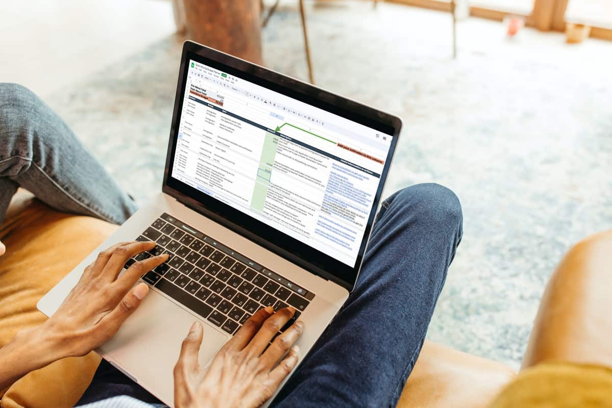 A lady using our Moving Budget planner on a laptop