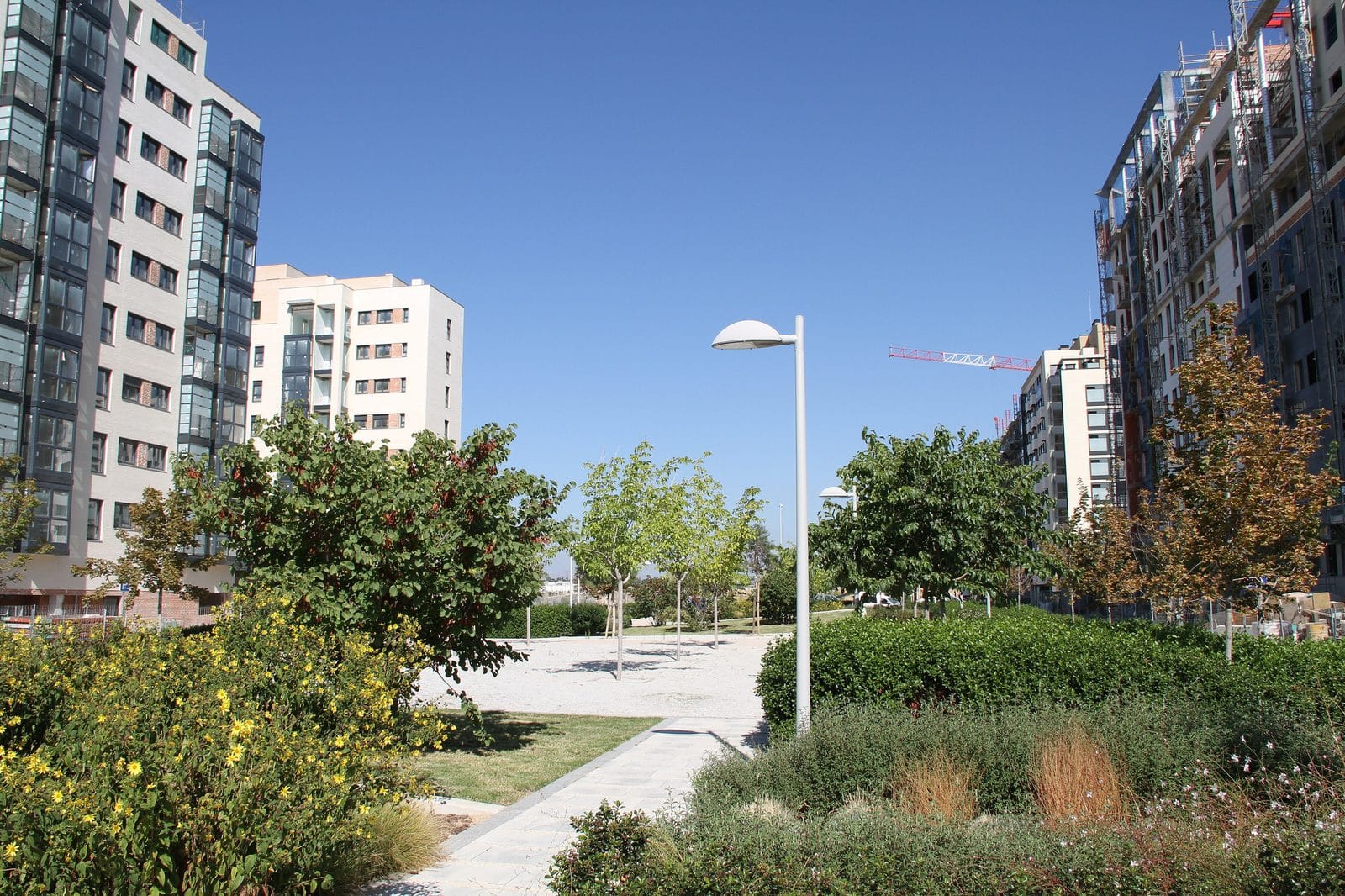 Modern apartment buildings with landscaped walkways in Madrid's Valdebebas new-build district