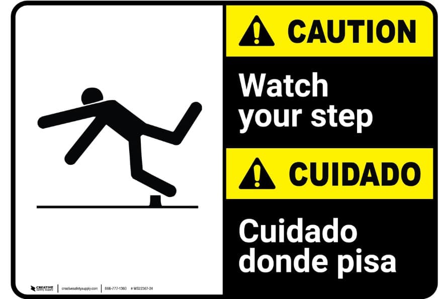 A Caution sign with correct Translations in Spanish and English