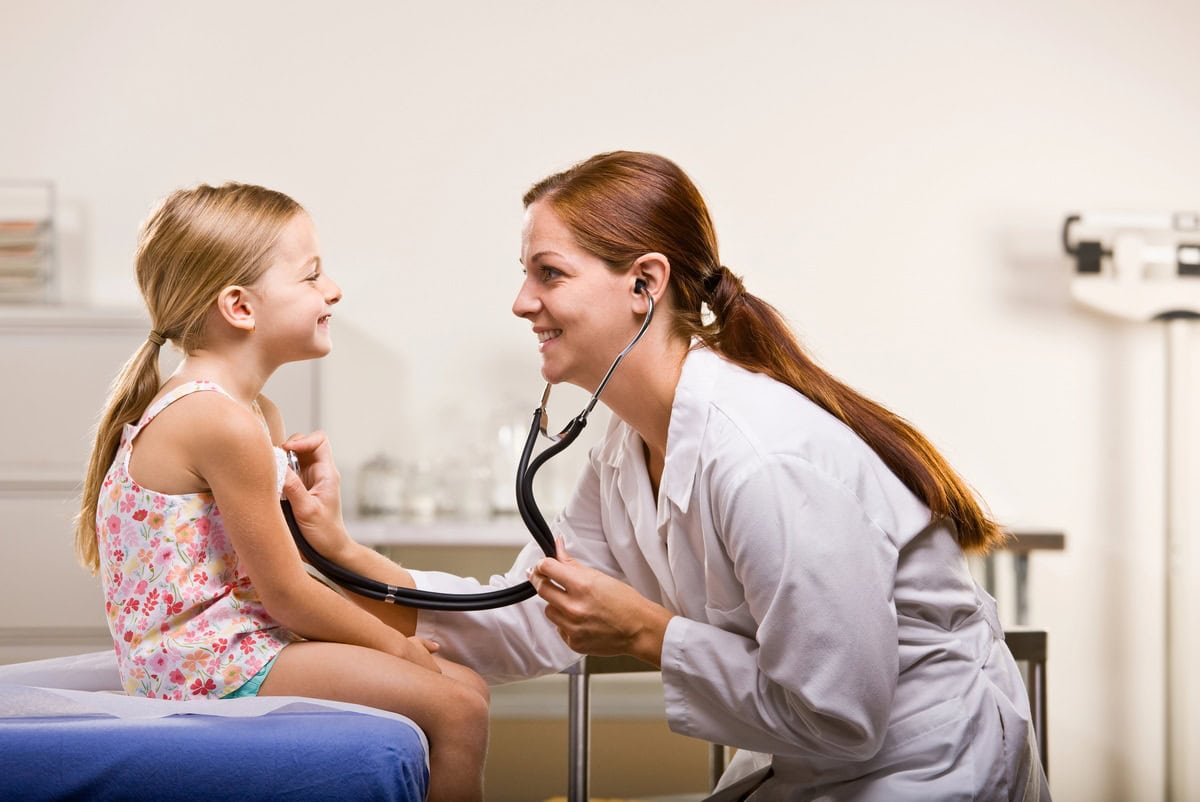 A doctor in the Spain public system helping a child