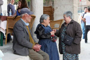 Spanish grandparents talking in a square