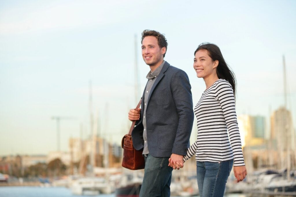Spanish citizenship by marriage is a fast path to EU citizenship. Couple walking in Port Vell, Barcelona, Spain